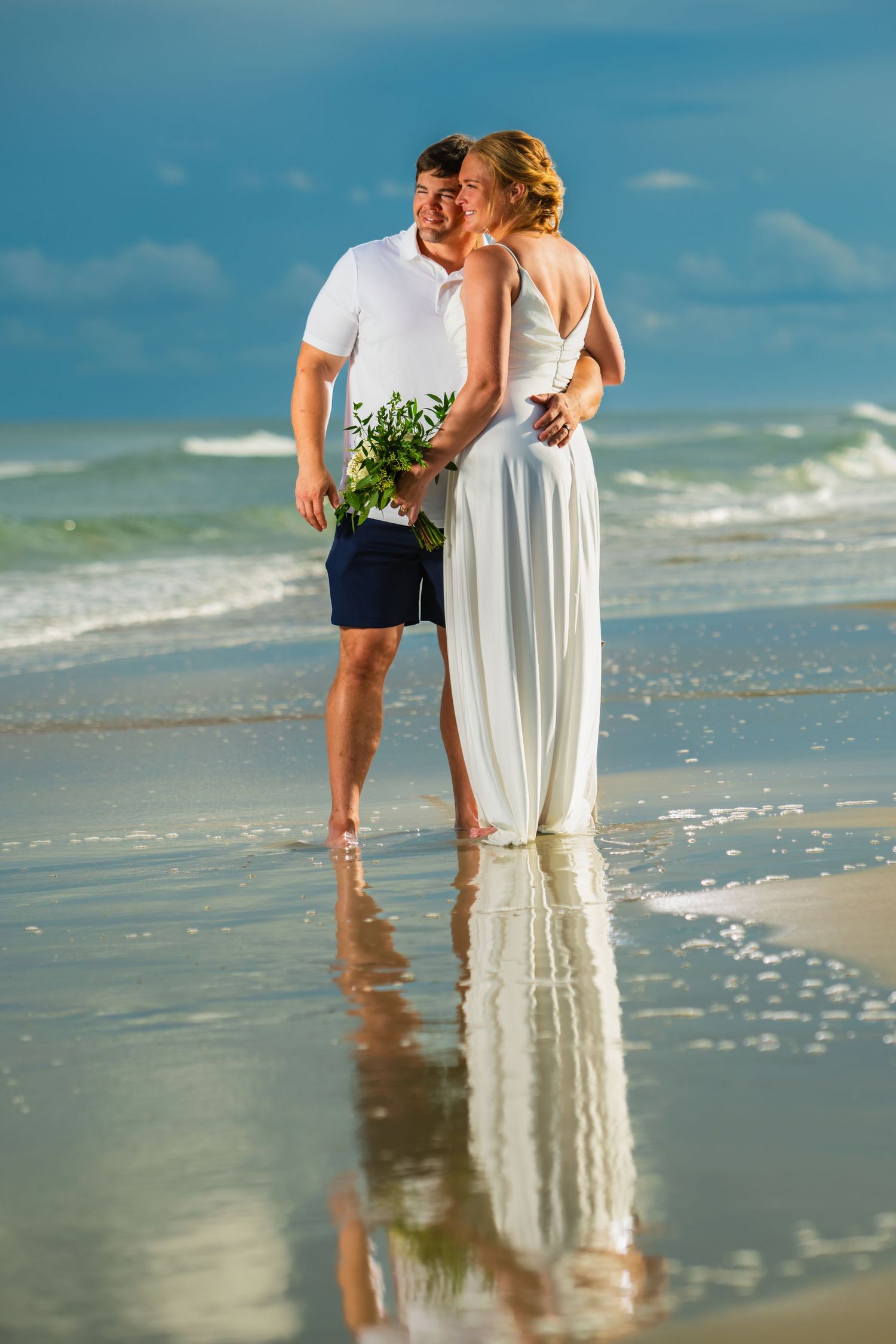 A romantic beach portrait with reflections in the wet sand and ocean waves in background. Myrtle beach photographer