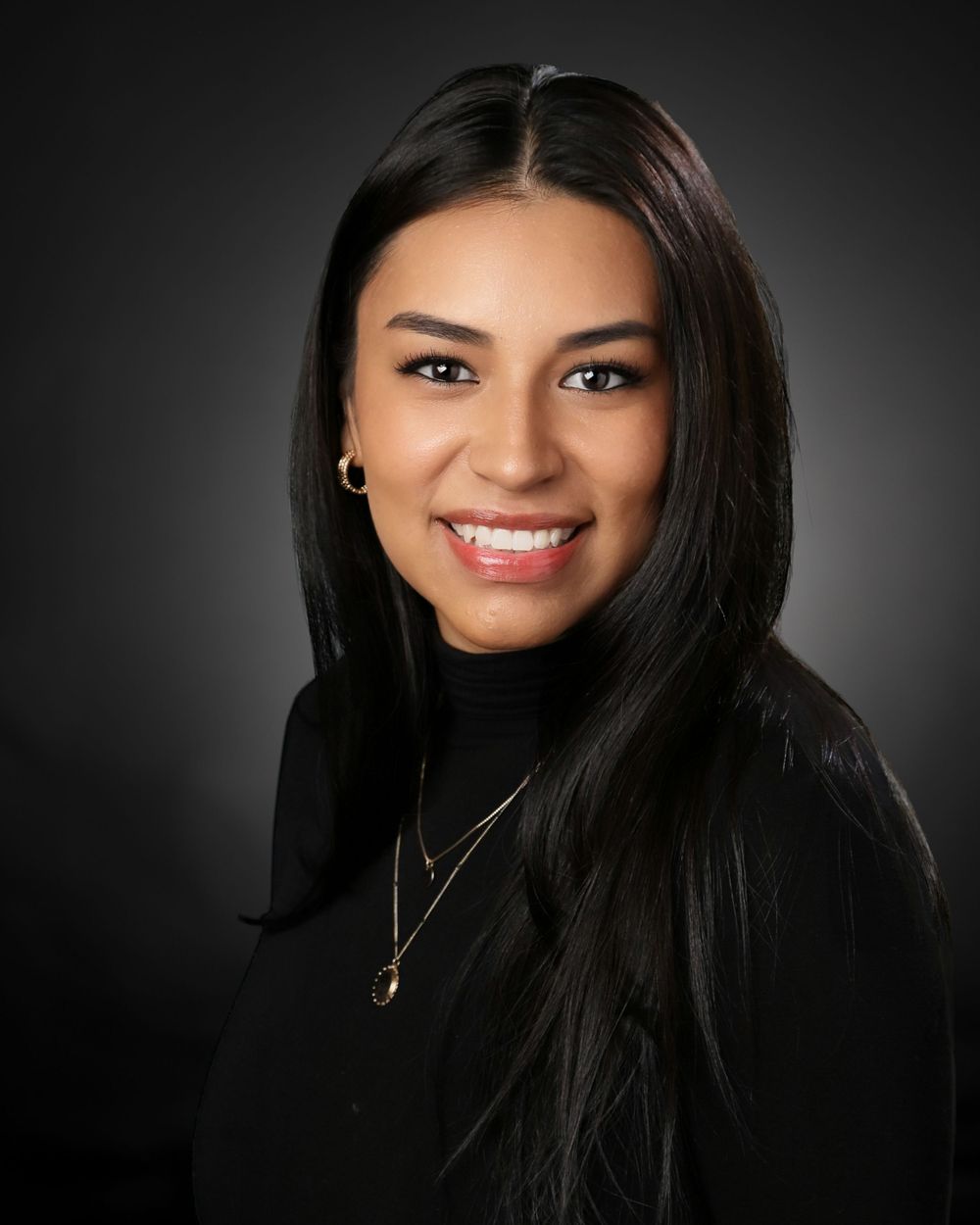 Professional studio portraits against dark background showcase elegant styling and dramatic lighting effects.
