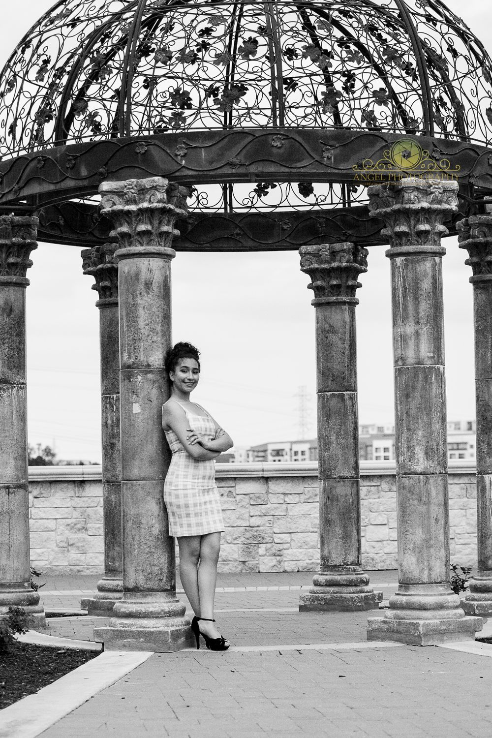 Black and white portrait under ornate stone gazebo with columned architecture.