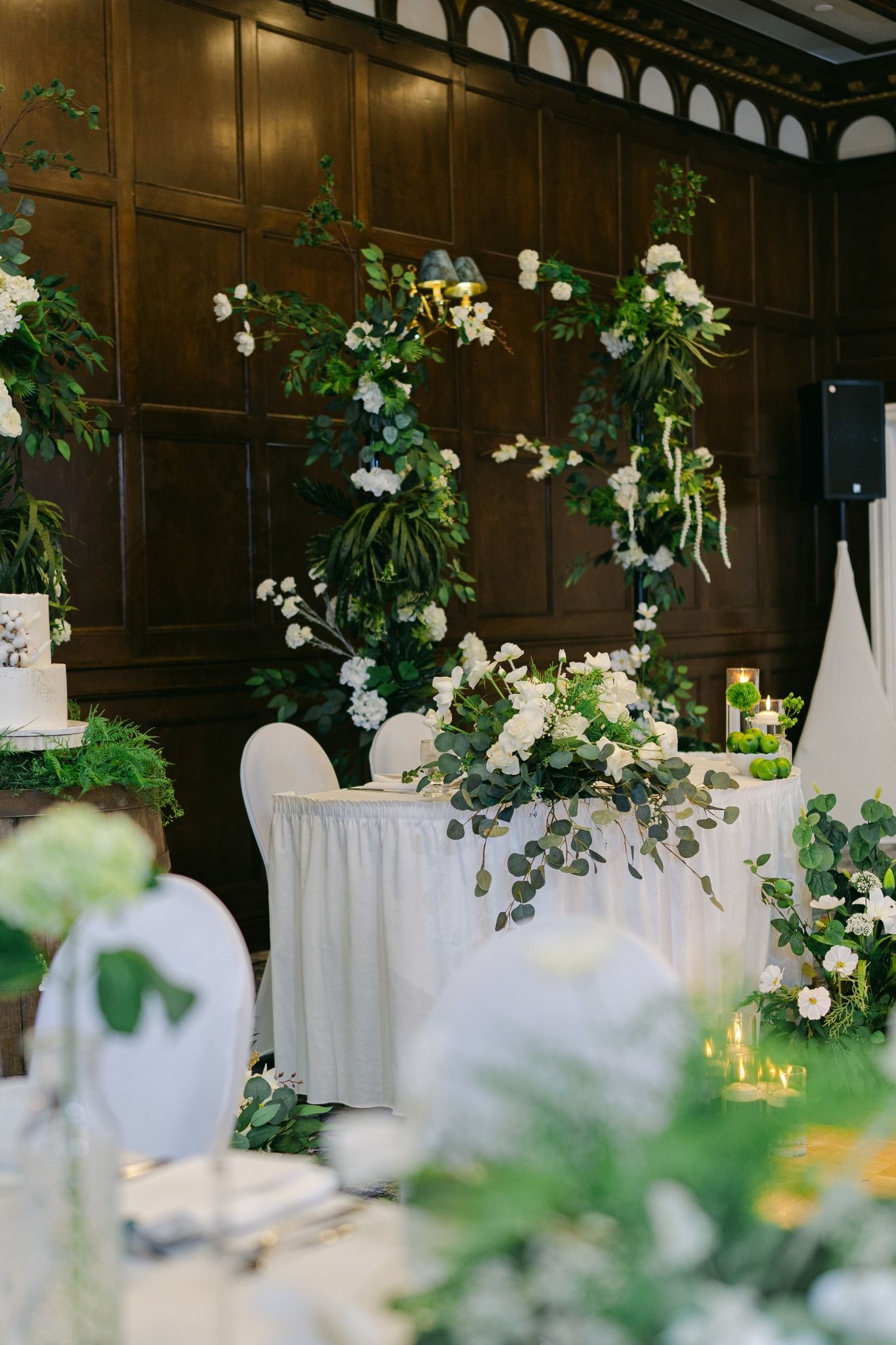 romantic wedding head table with cascading greenery and floral styling in Regina event decor