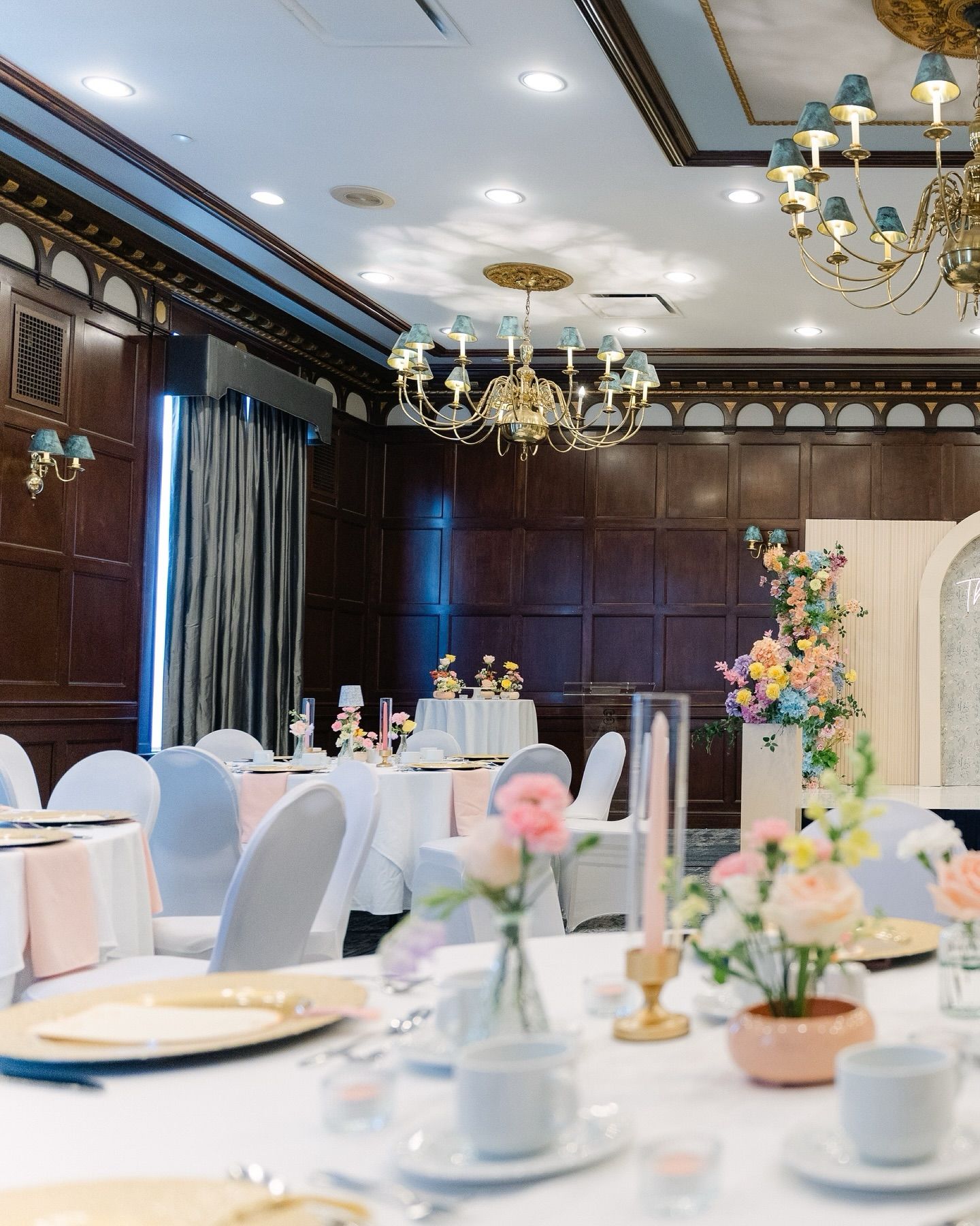 wedding reception setup with decorated tables, changeliers, and floral styling in Regina wedding venue
