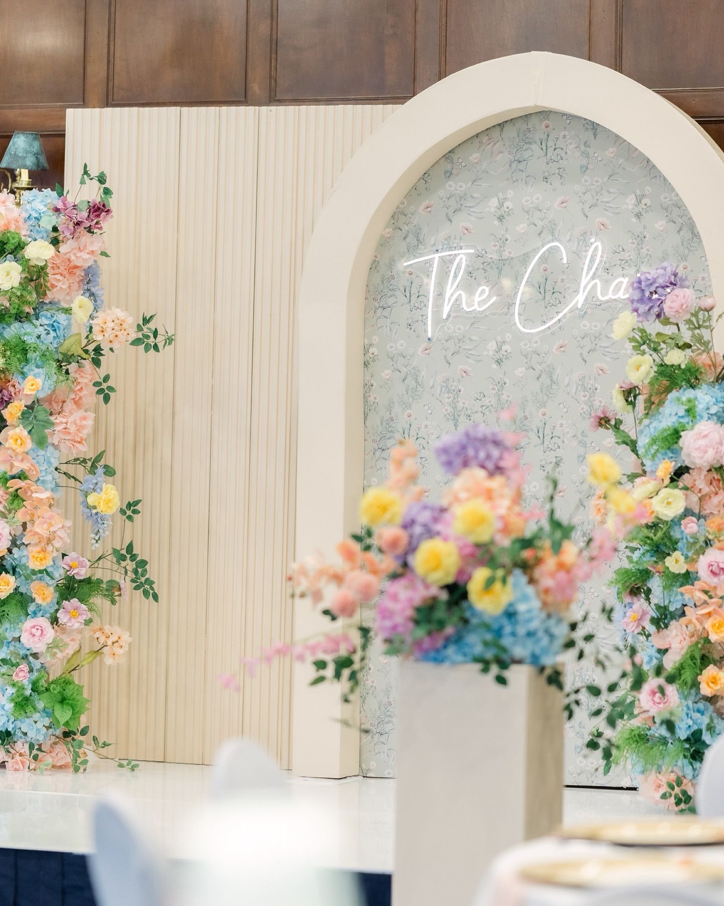 elegant wedding ceremony backdrop with pastel floral arrangements and modern arch design in Regina wedding styling
