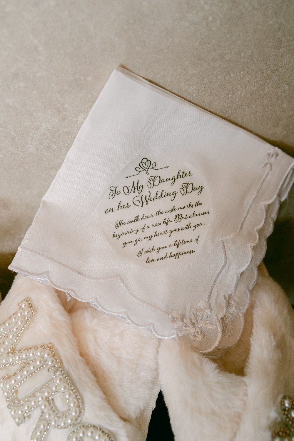 An embroidered white wedding handkerchief with 'To My Daughter on her Wedding Day' message.