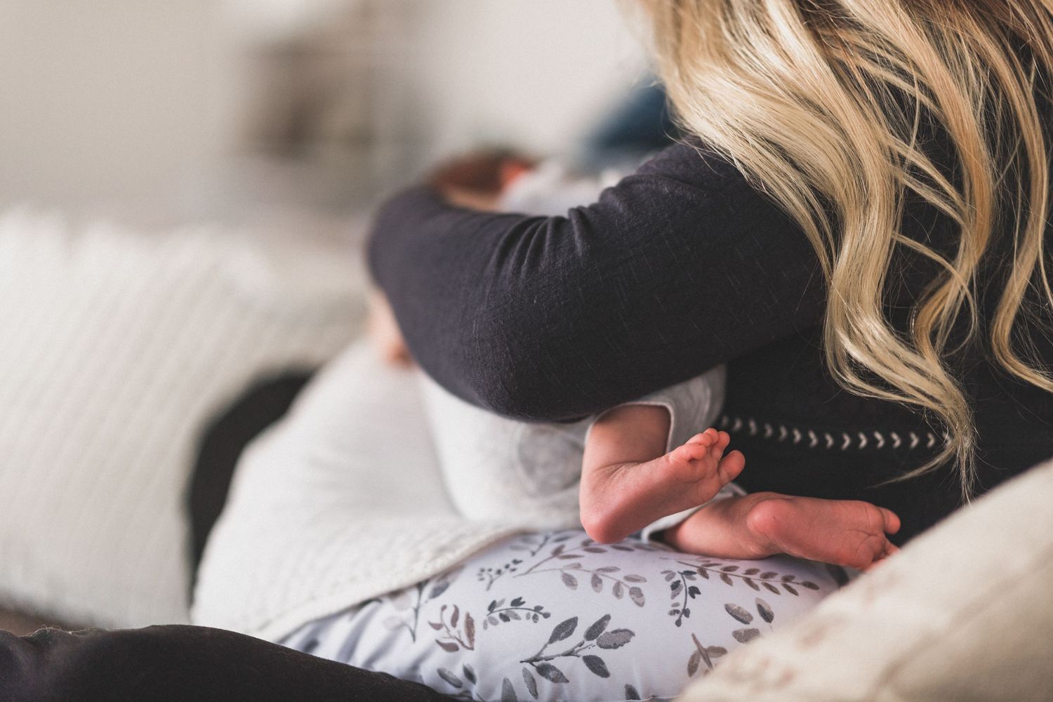 Detail shot of baby's feet while mother nurses