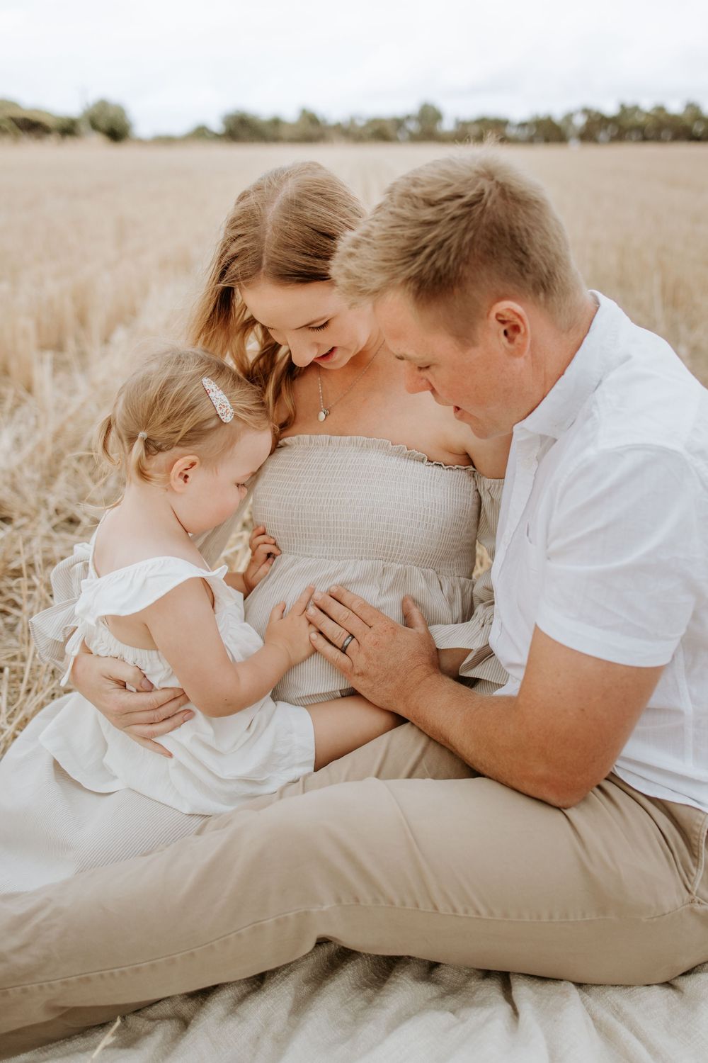 Young family during a natural sunset pregnancy photography session at Port Willunga, South Australia