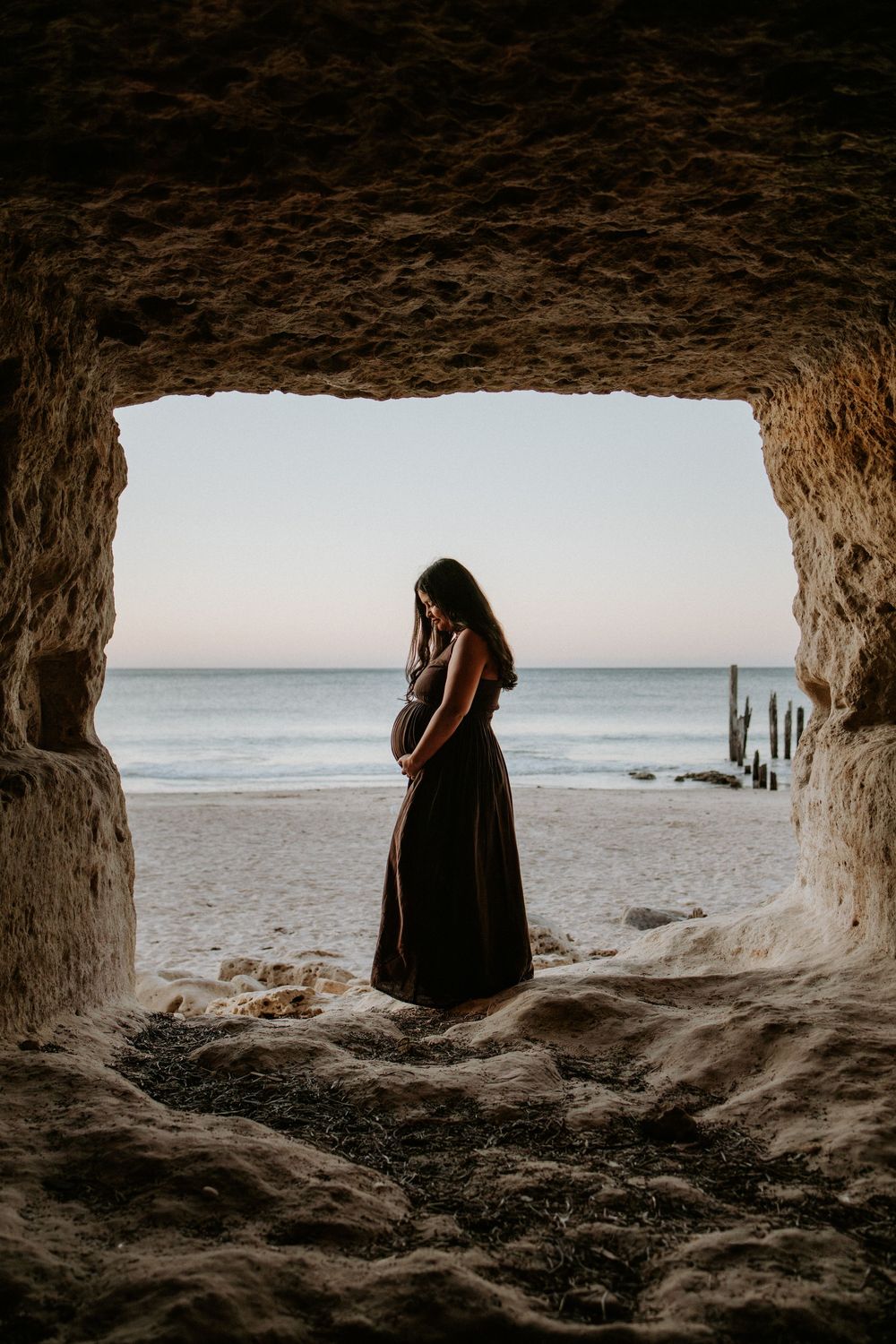 Pregnant mother photographed inside the boat caves during a relaxed maternity session at Port Willunga, South Australia