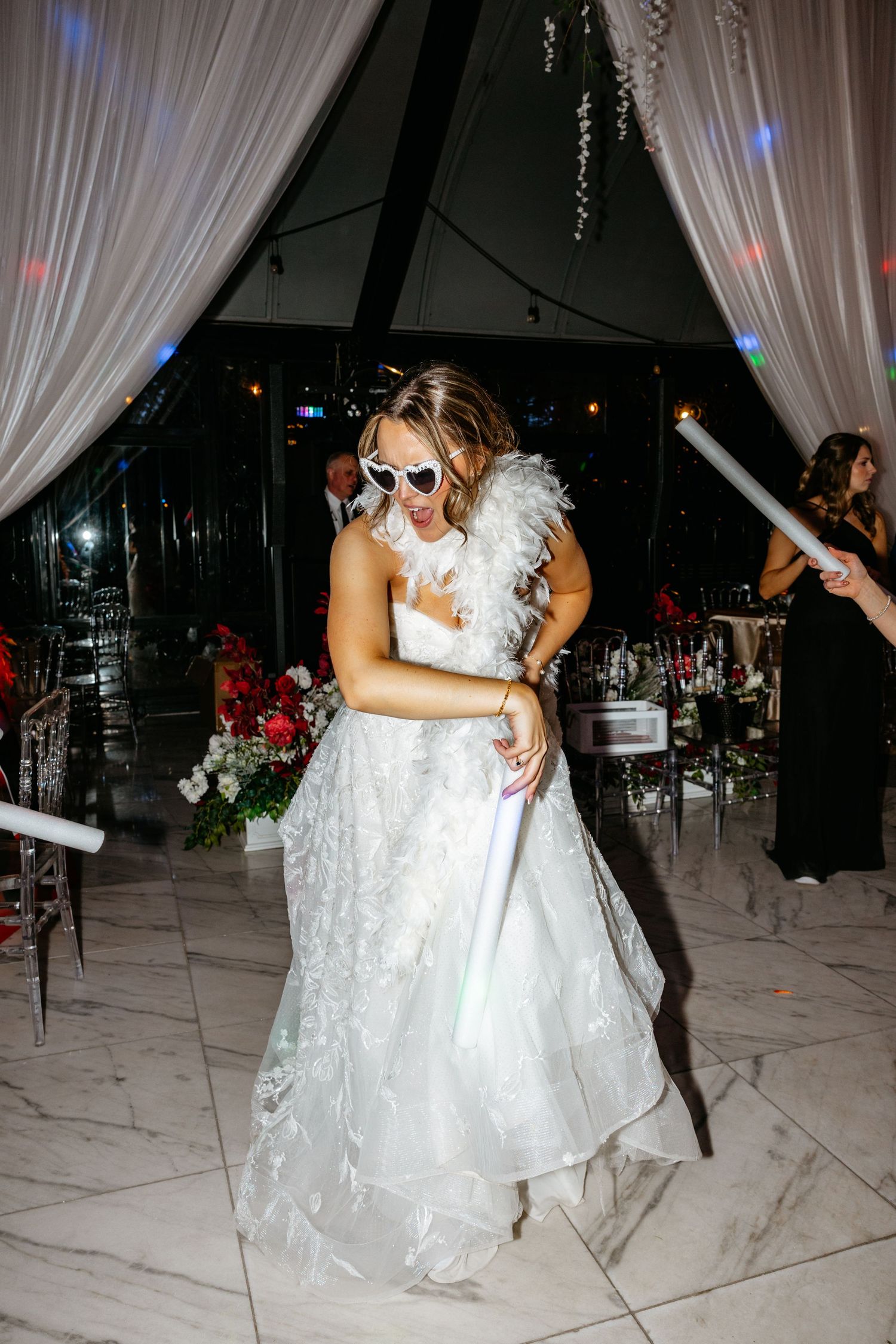 Sequence of dance moves during wedding reception with bride in white lace gown being dipped on dance floor.