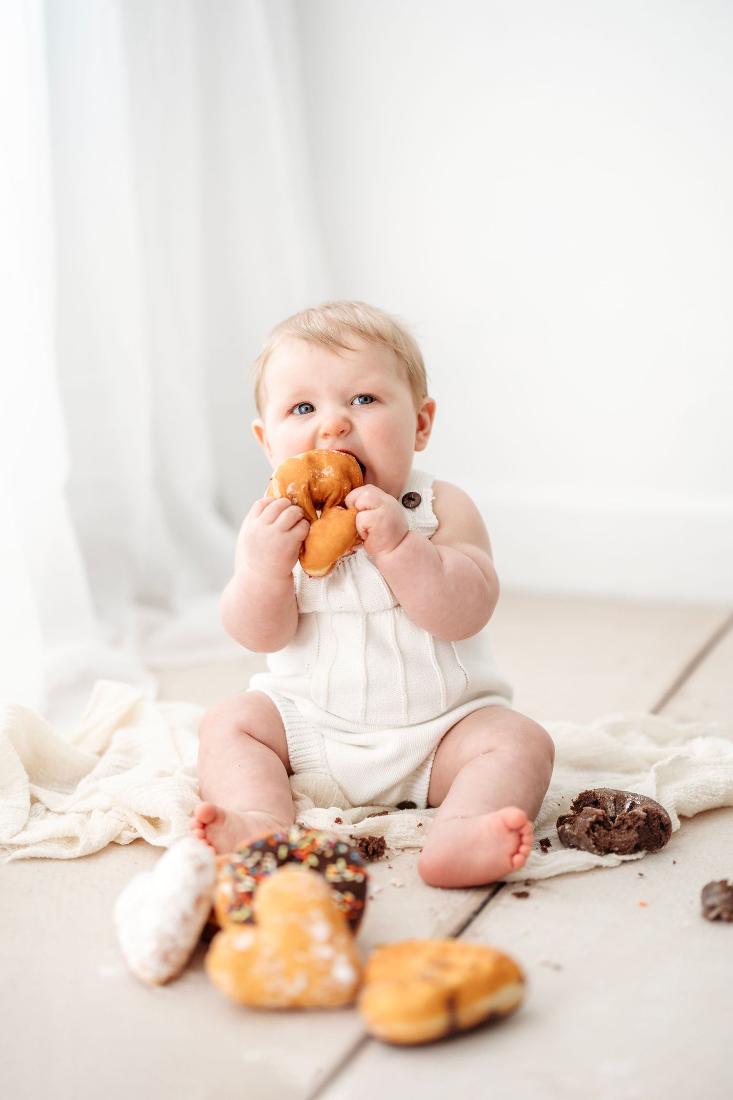 six month old eating donuts. Middle TN milestone photographer.