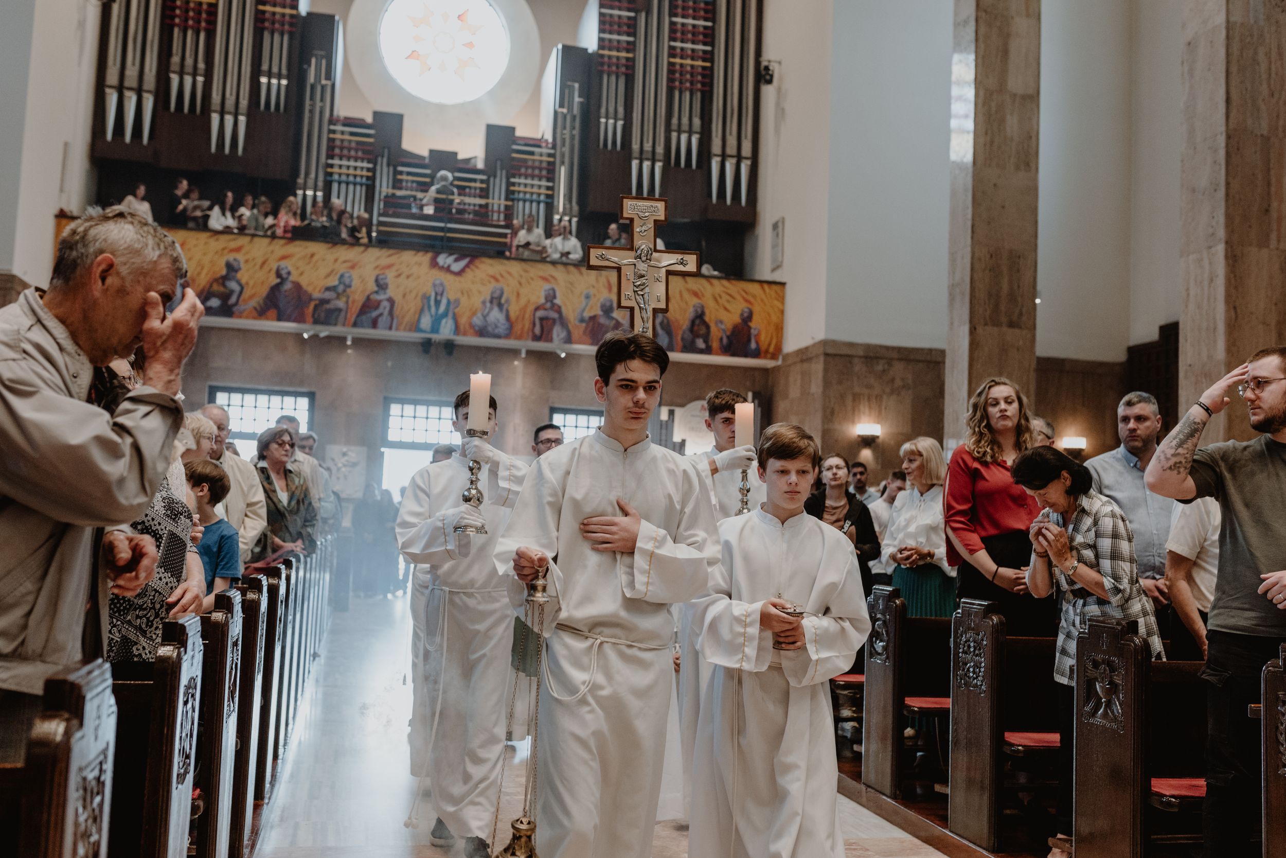 Opening moments of the Holy Mass during christening, with family seated at the front row.