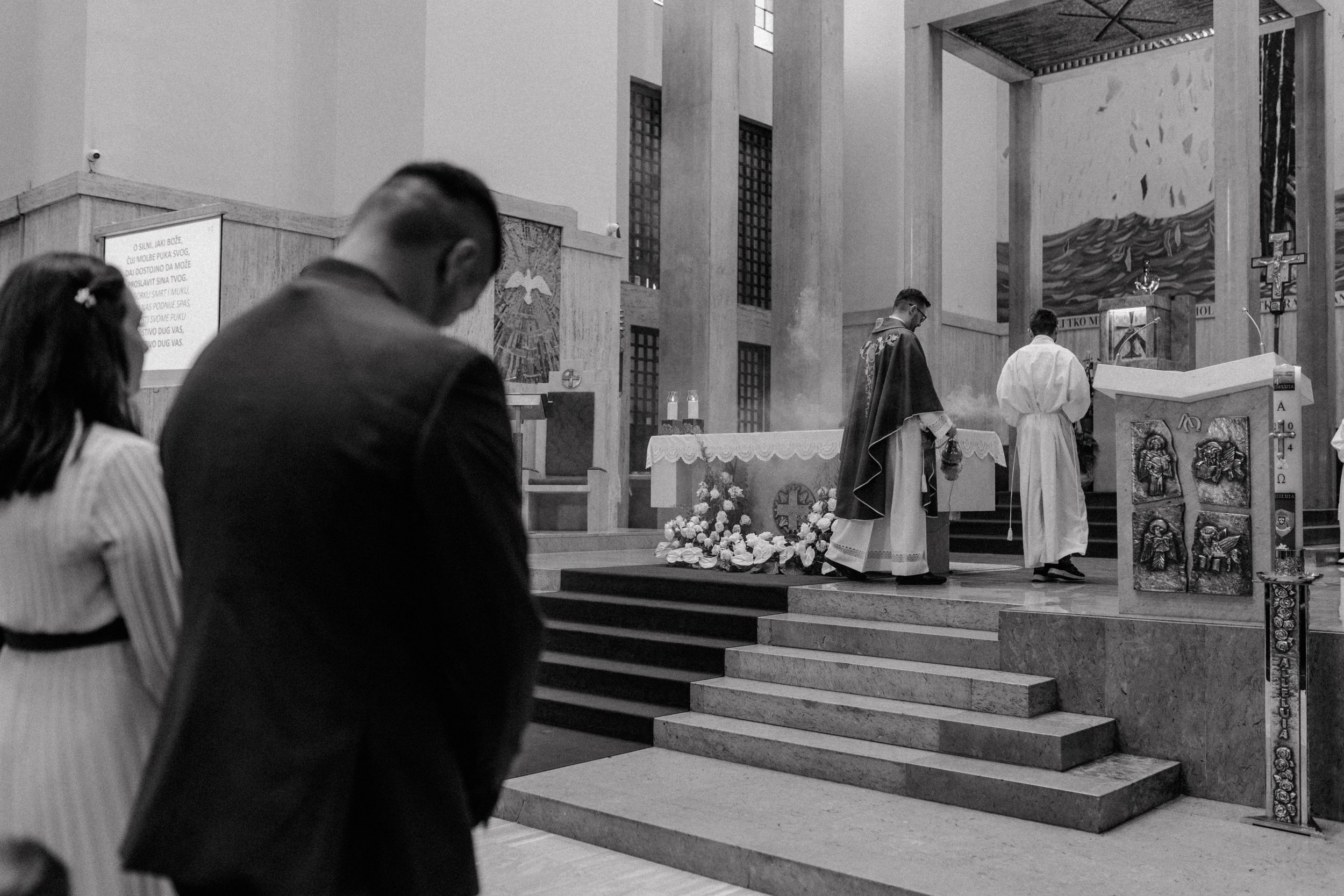Opening moments of the Holy Mass during christening, with family seated at the front row.