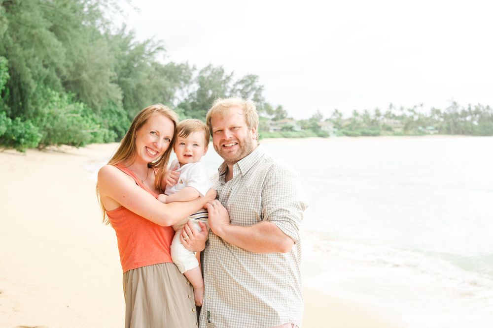 Happy family moment captured on tropical beach with palm trees. Oahu Family Photographer