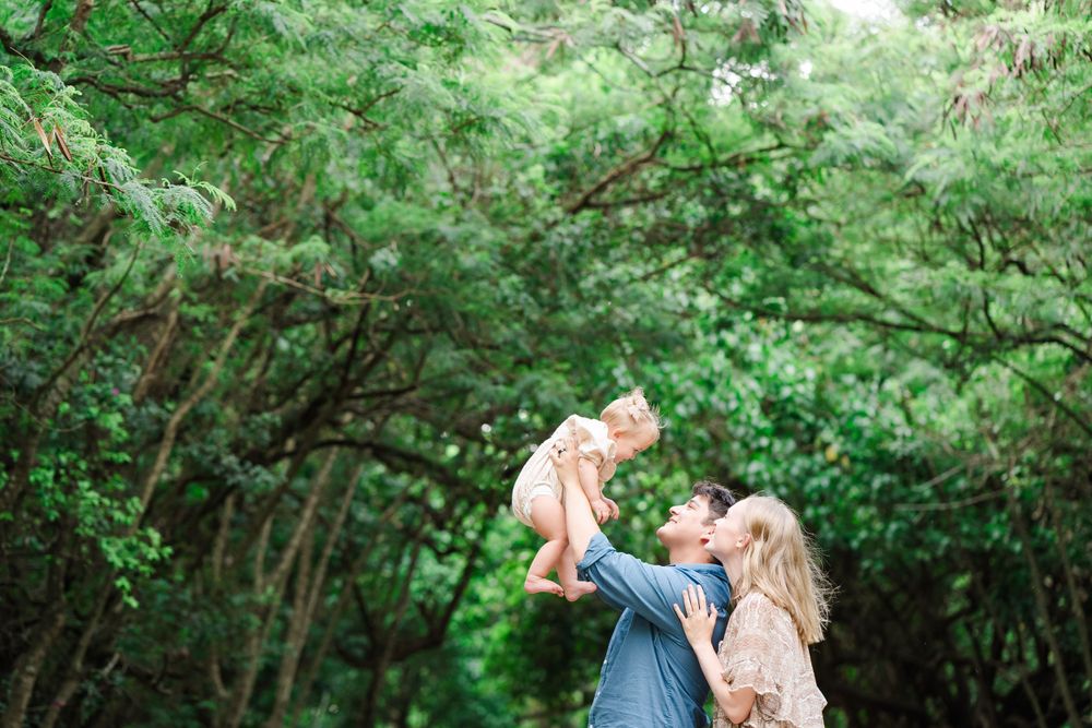 Joyful moment captured in a lush green forest setting.