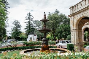 Curzon Hall garden fountain beside the sandstone mansion