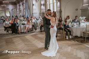 Newlyweds sharing their first dance in a Curzon Hall ballroom