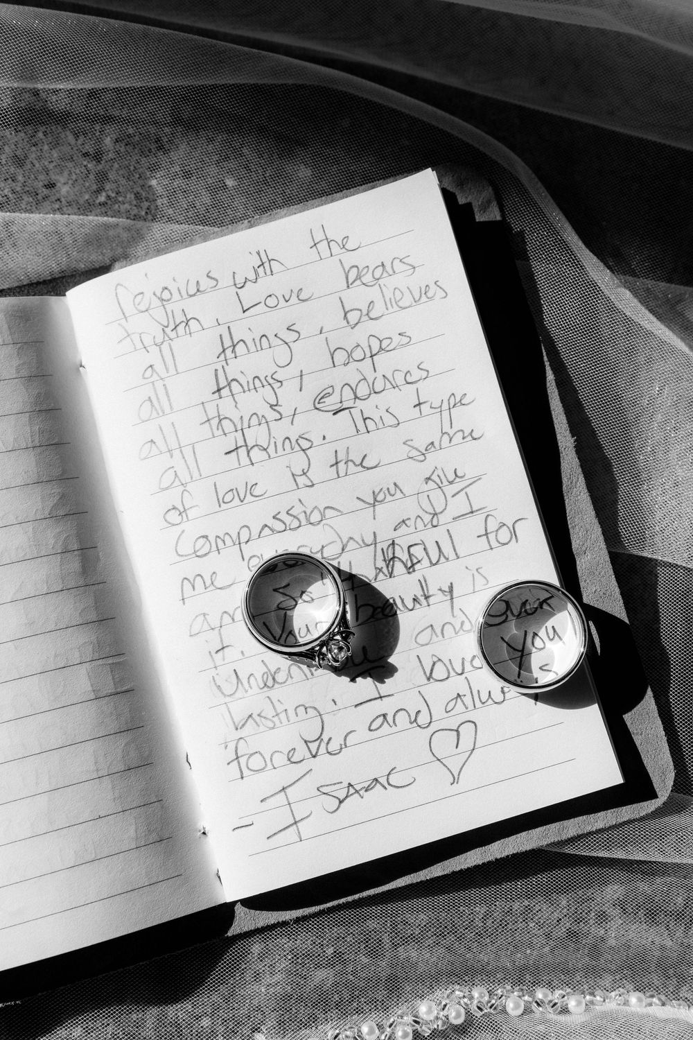 A handwritten note on lined paper with earbuds resting on top, captured in black and white photography.