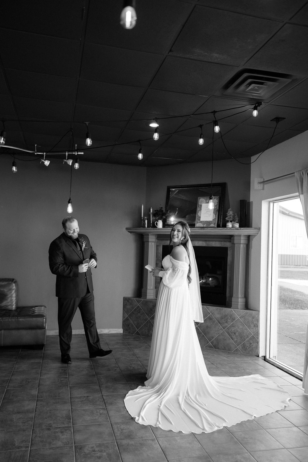 A series of black and white wedding photos showing a couple in formal attire standing together in an empty venue space.