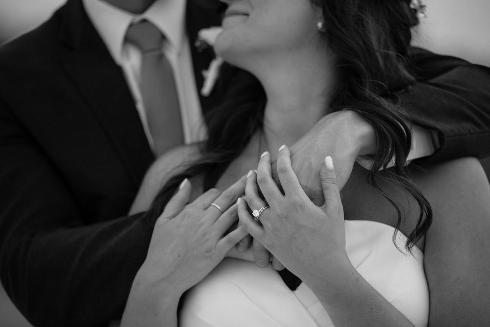 A series of black and white romantic photos showing intimate moments between a couple on their wedding day.