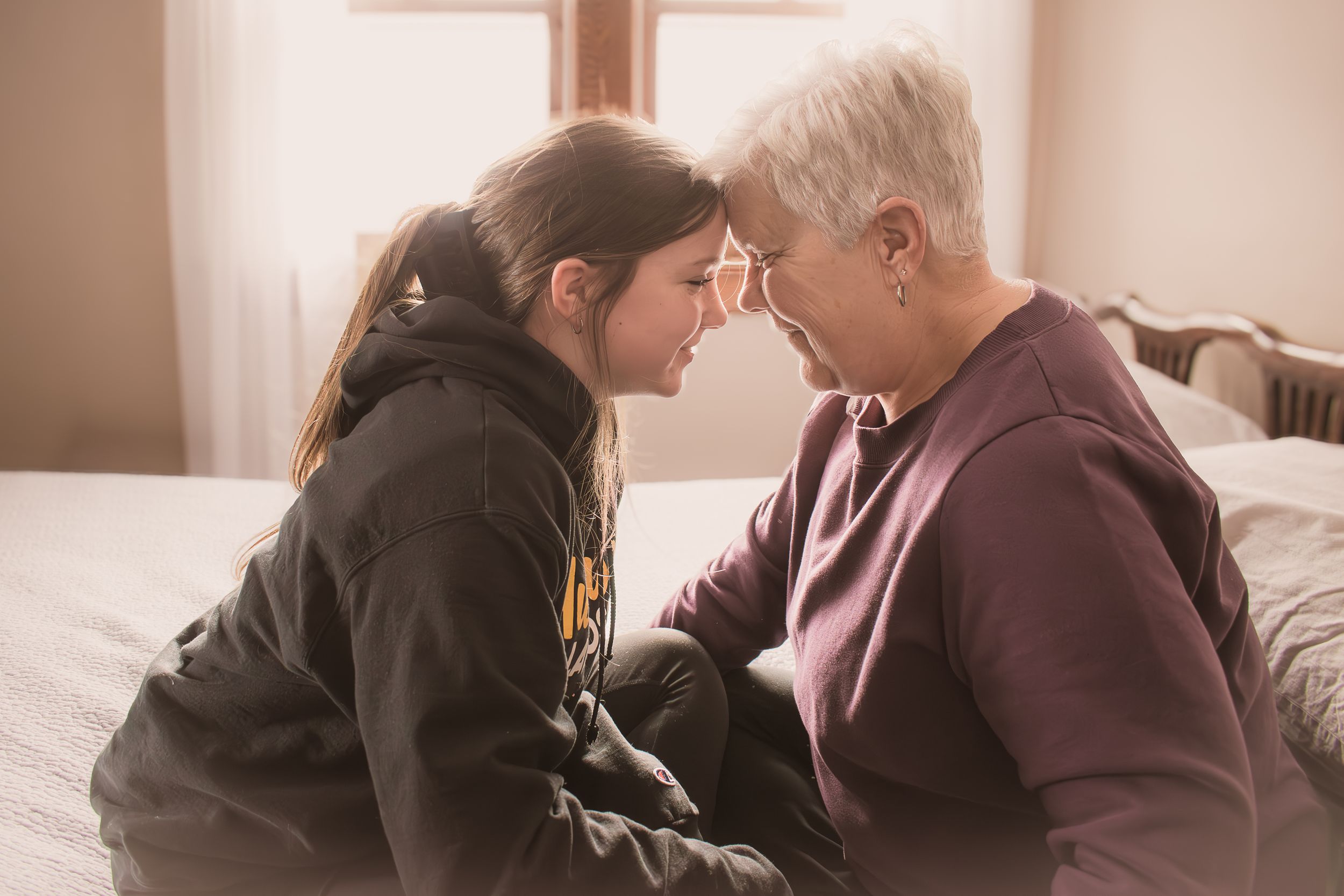 Photography of a Grandmother and Granddaughter sharing a special moment together.  Blue Onion Photography.