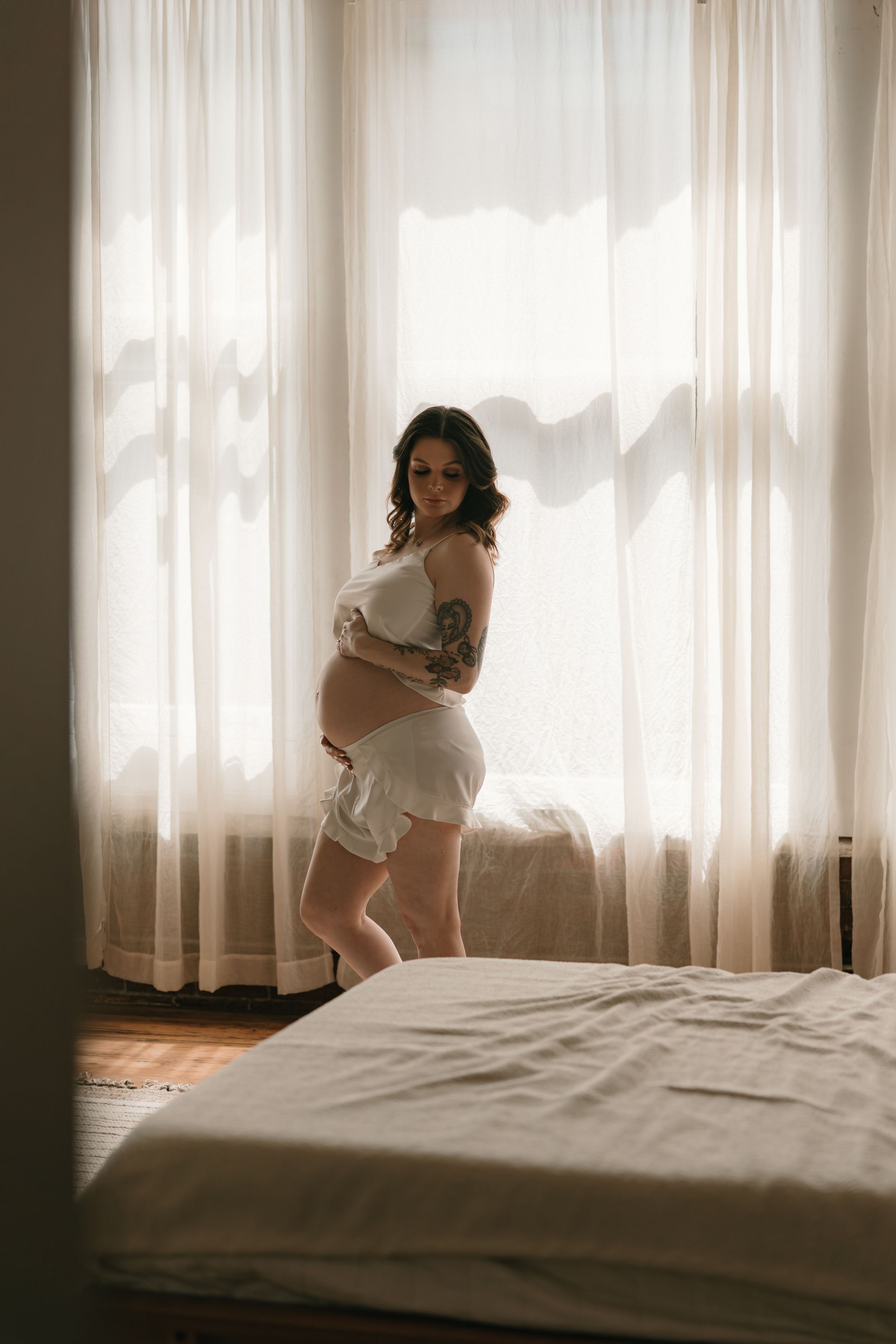 A series of minimalist photos showing a figure in white against sheer curtains in a bright bedroom setting.