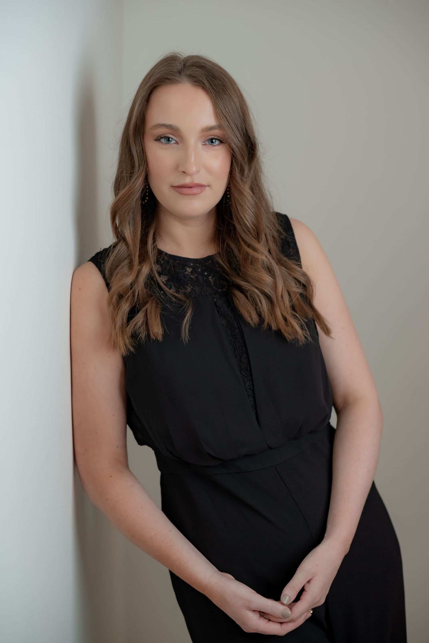beautiful young woman wearing black jumpsuit and long hair in studio connie shuffett photography