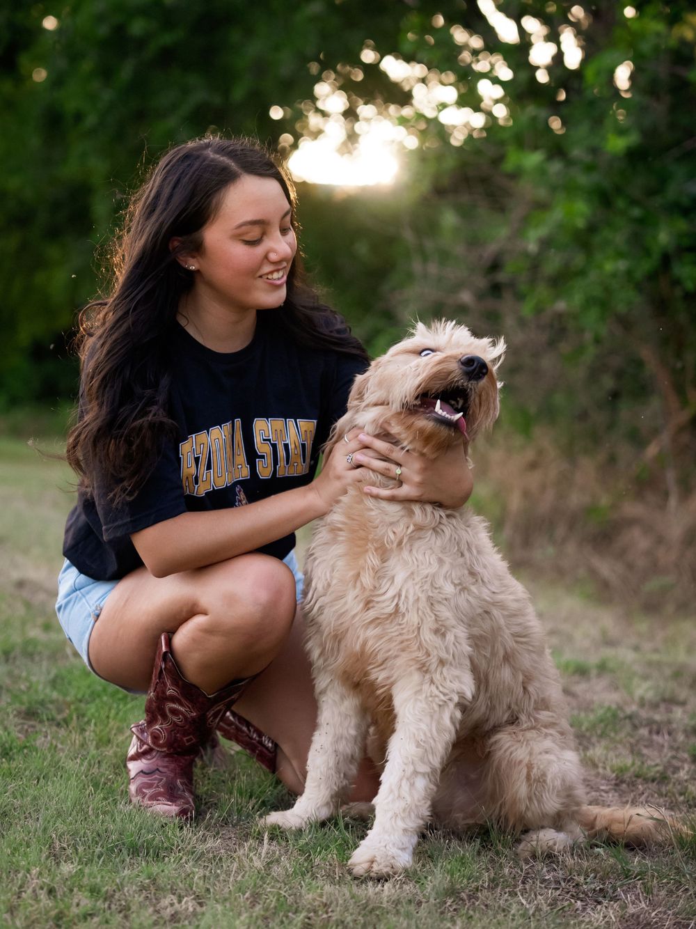 Candid moment with a happy goldendoodle in a natural outdoor setting at sunset.