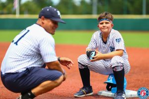 Baseball coach and player discussing strategy during a game.