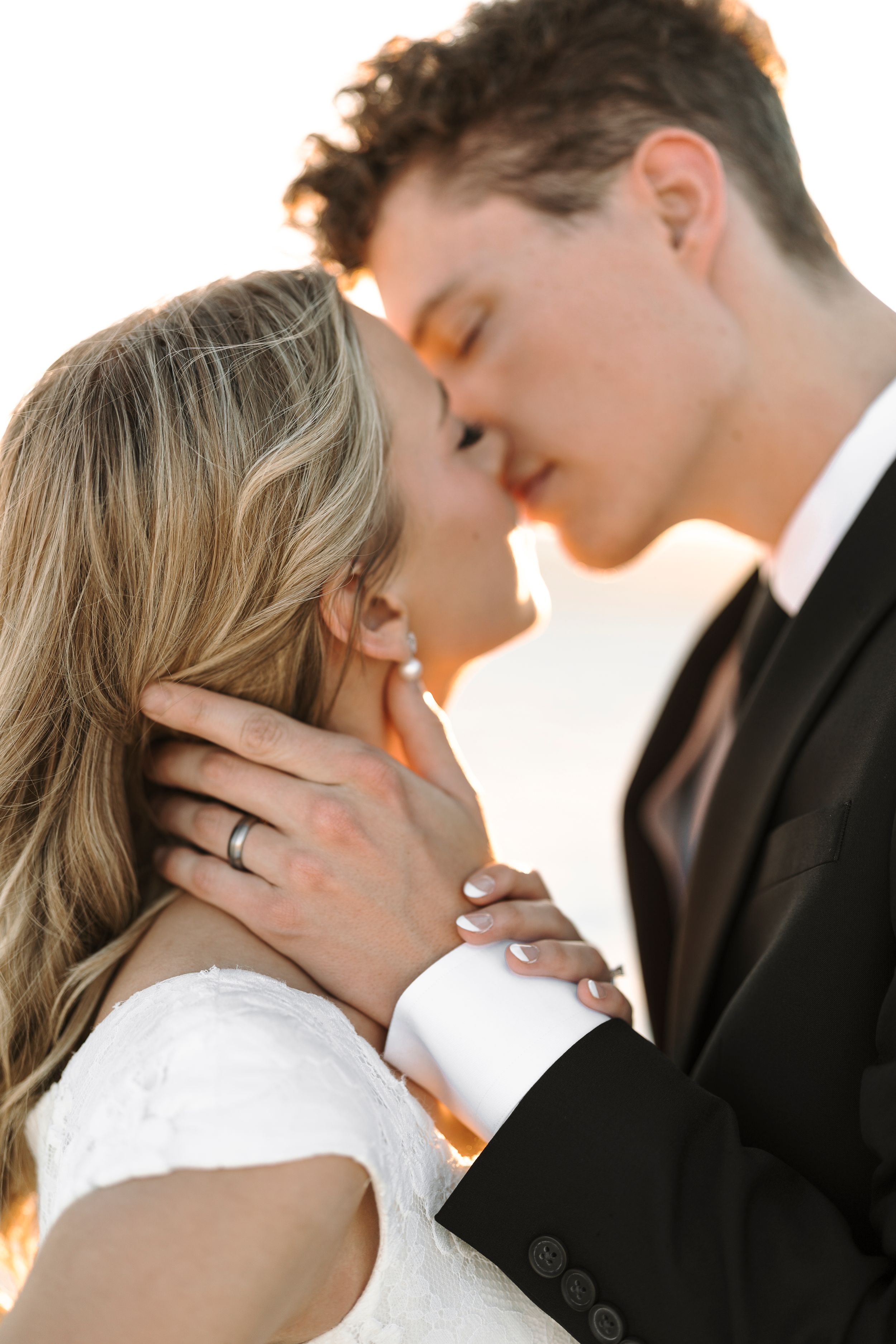 Four romantic close-up photos of bride and groom sharing intimate kisses during wedding portrait session at sunset.