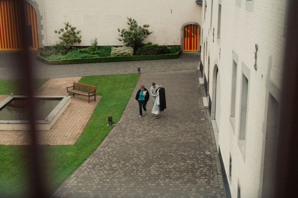 Aerial view of people walking through a courtyard between white buildings.