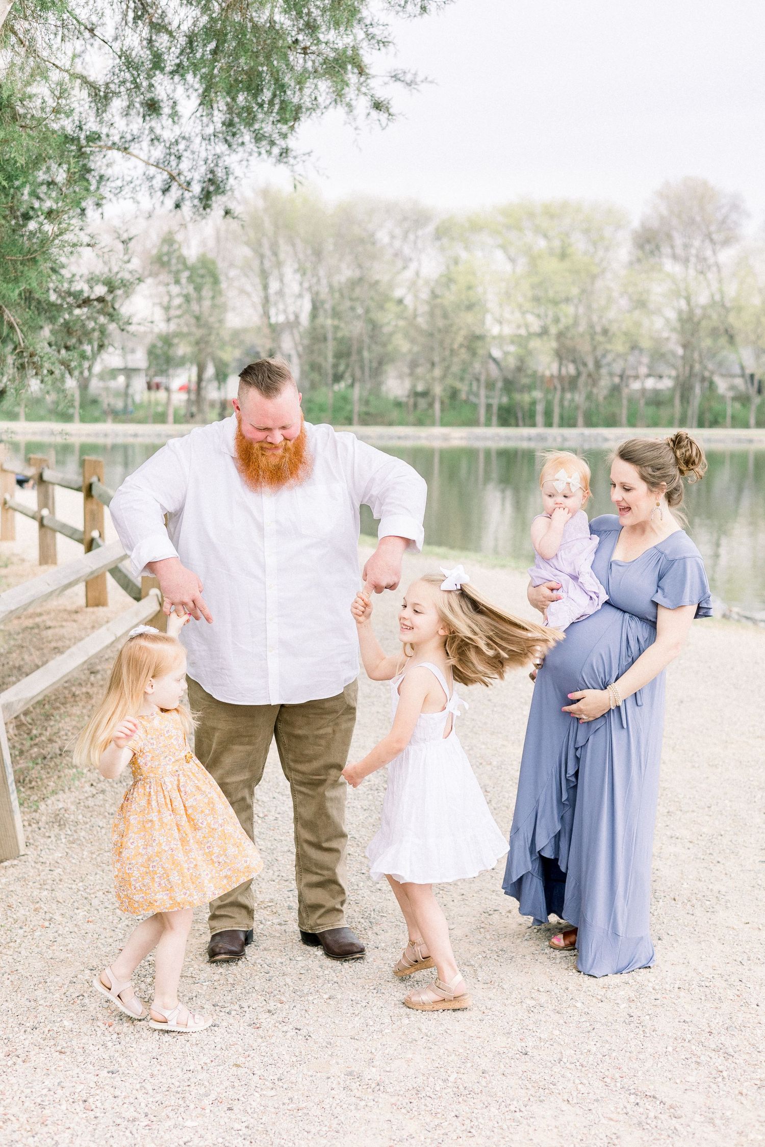 Family photo with siblings bonding during outdoor maternity session in Augusta, GA.
