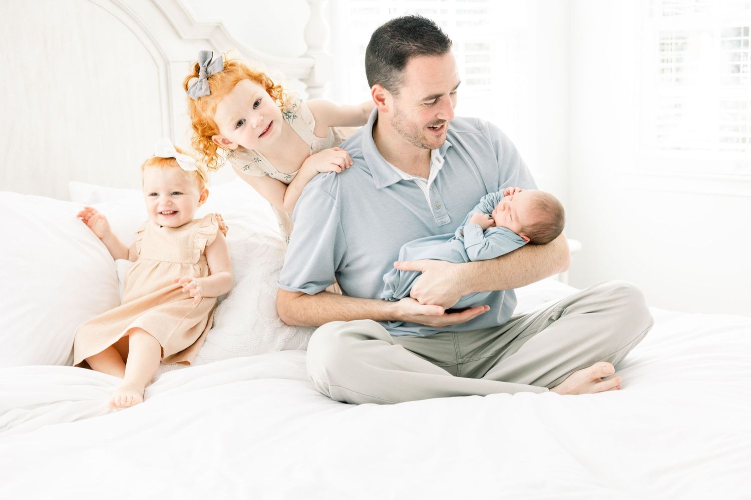 Candid moment of siblings playing together in a newborn session in Augusta, GA.