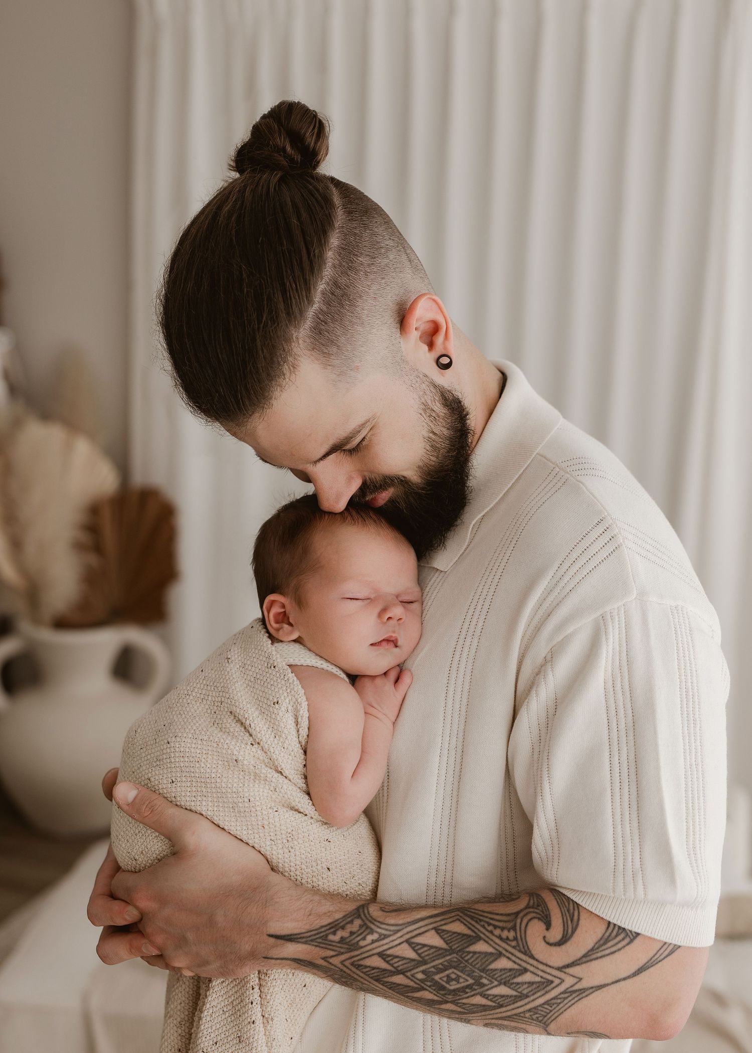 A tender moment captured in a series of black and white photos showing a parent cradling and embracing a sleeping infant.