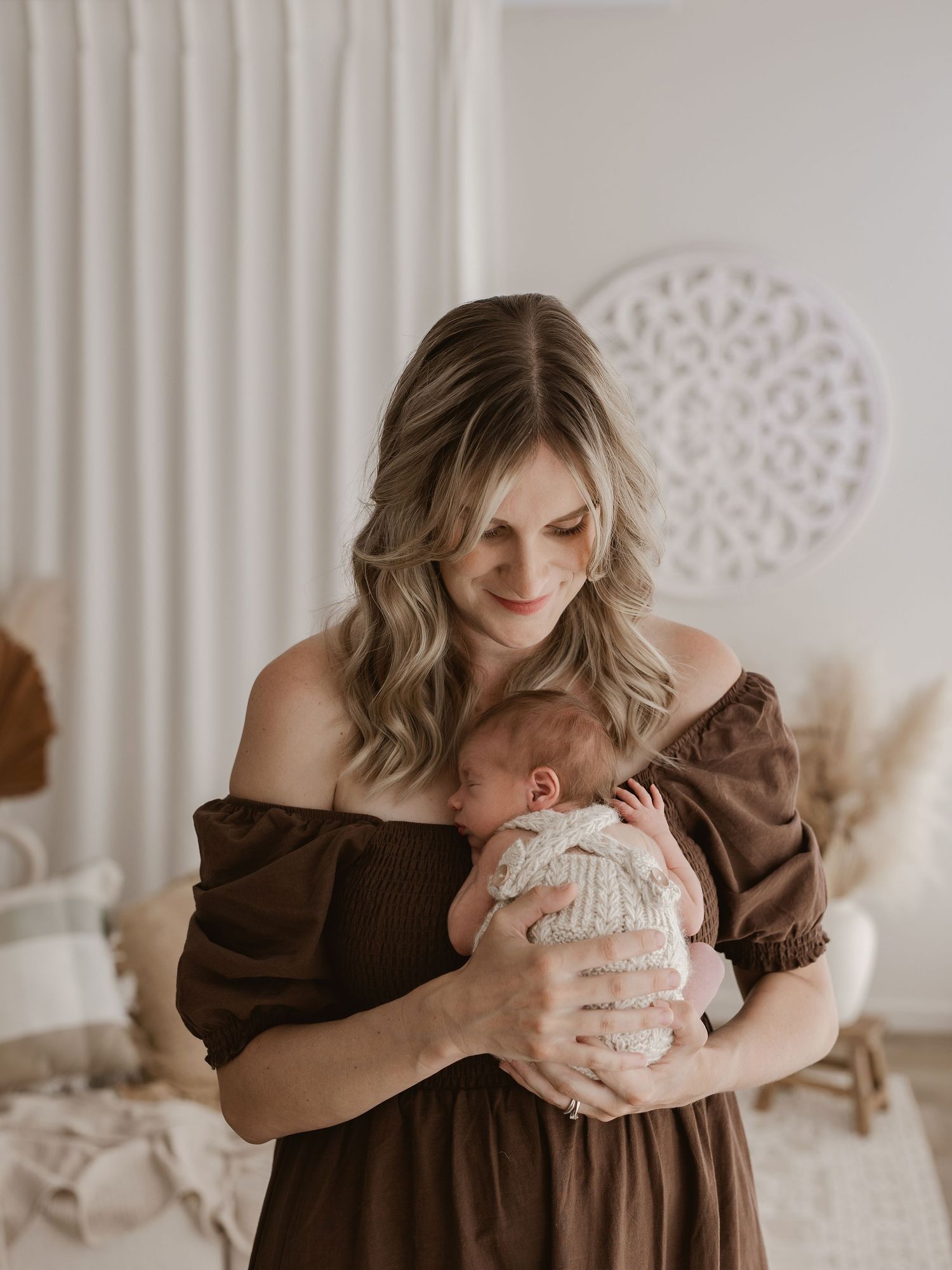 A series of tender moments captured in soft, neutral tones showing parent and baby bonding in a light-filled room.