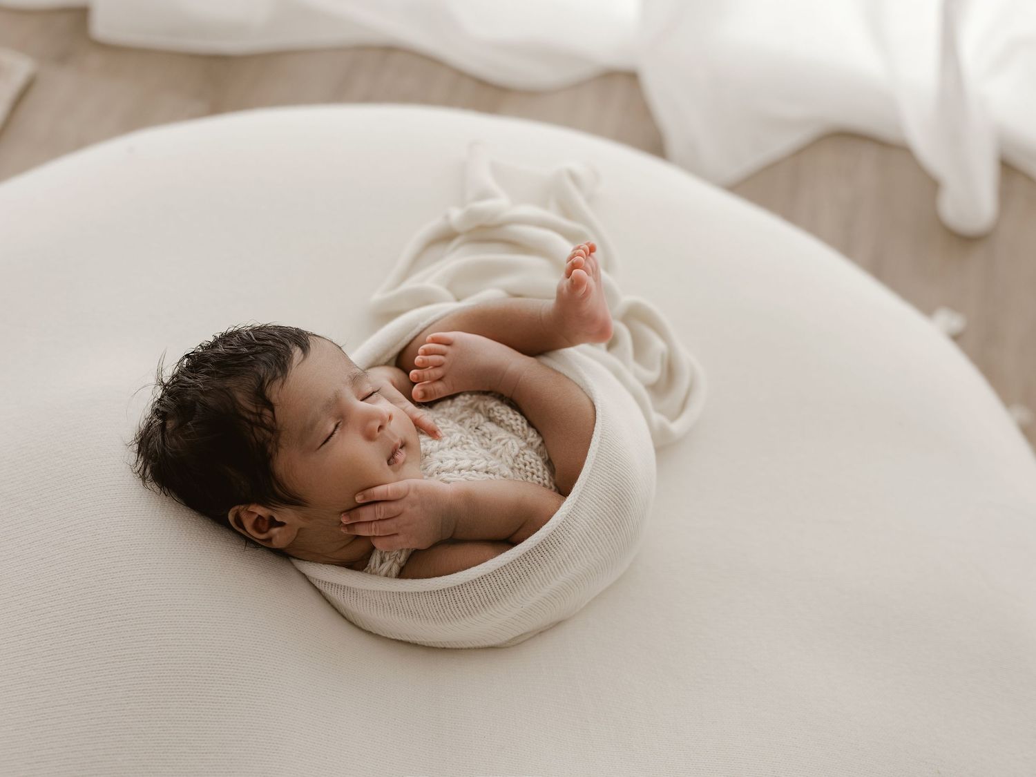 A peaceful series of sleeping baby photos on soft white bedding shows gentle poses and natural lighting.