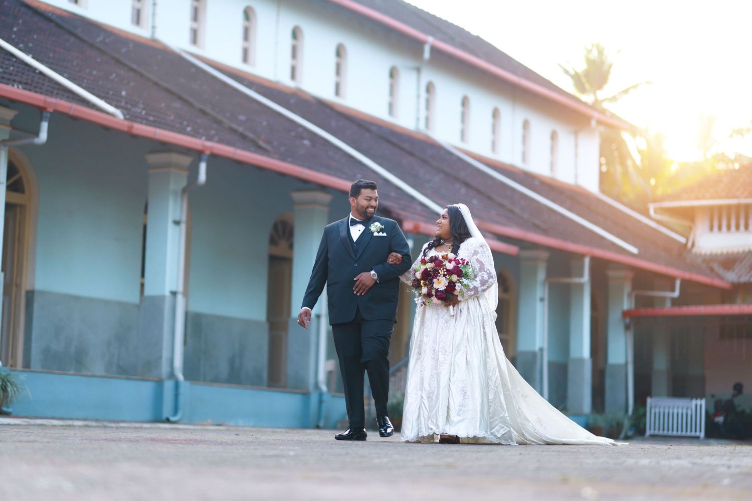Bride and groom walking together outside a wedding venue