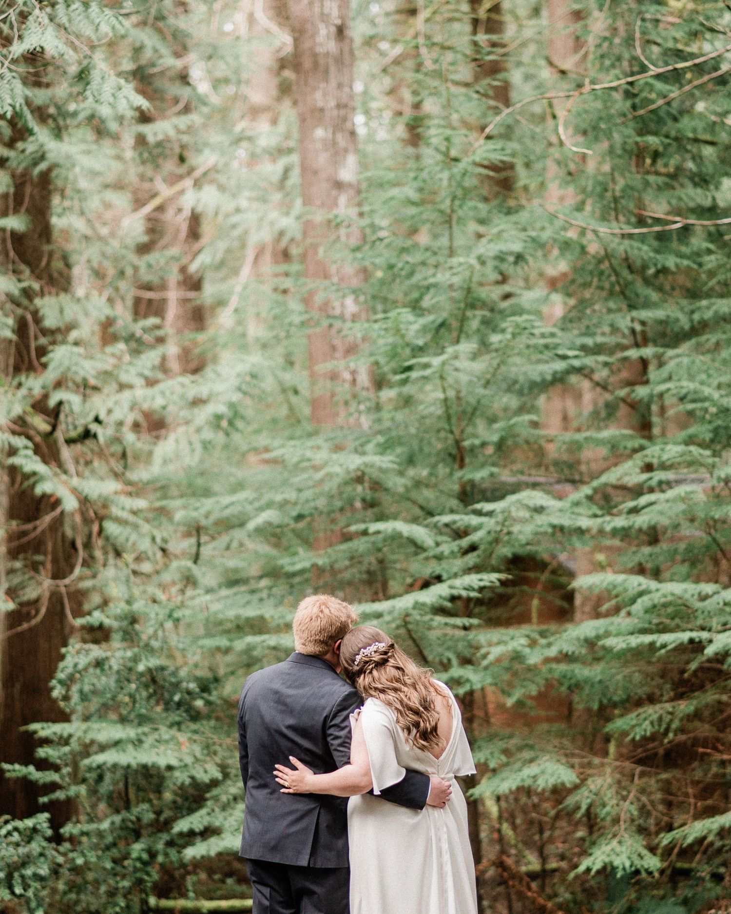 bride and groom hugging in forest. Photo by Harstine Island elopement photographer, Tori Shults.