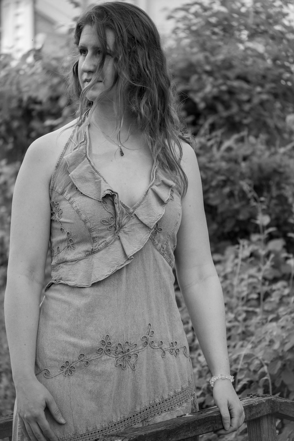 A series of portraits featuring a ruffled gray dress with delicate embroidery details.