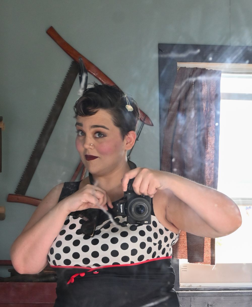 Person in retro polka dot dress with dark hair and makeup poses playfully in vintage pinup style photos.