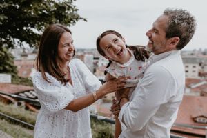 Family enjoying a relaxing afternoon in Upper Town, with candid moments of joy and togetherness.