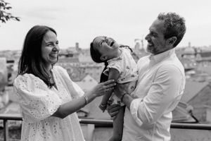 Family enjoying a tickle fight with their daughter during an afternoon photoshoot in Upper Town.