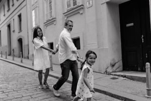 "Family walking hand-in-hand through the charming streets of Upper Town, capturing genuine smiles and connections.