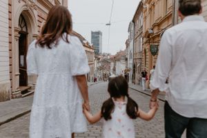 Playful family interaction in Upper Town, with children exploring and parents enjoying the day.