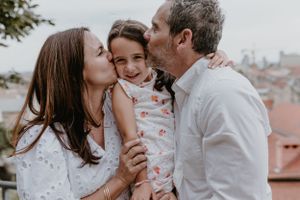 Moments of laughter and love during a family photo session in Upper Town, featuring scenic city views.