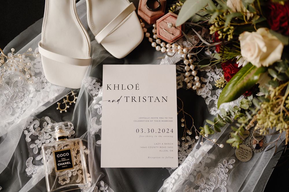 Elegant wedding stationery and floral details arranged on marble surface. Oklahoma Wedding Photographer