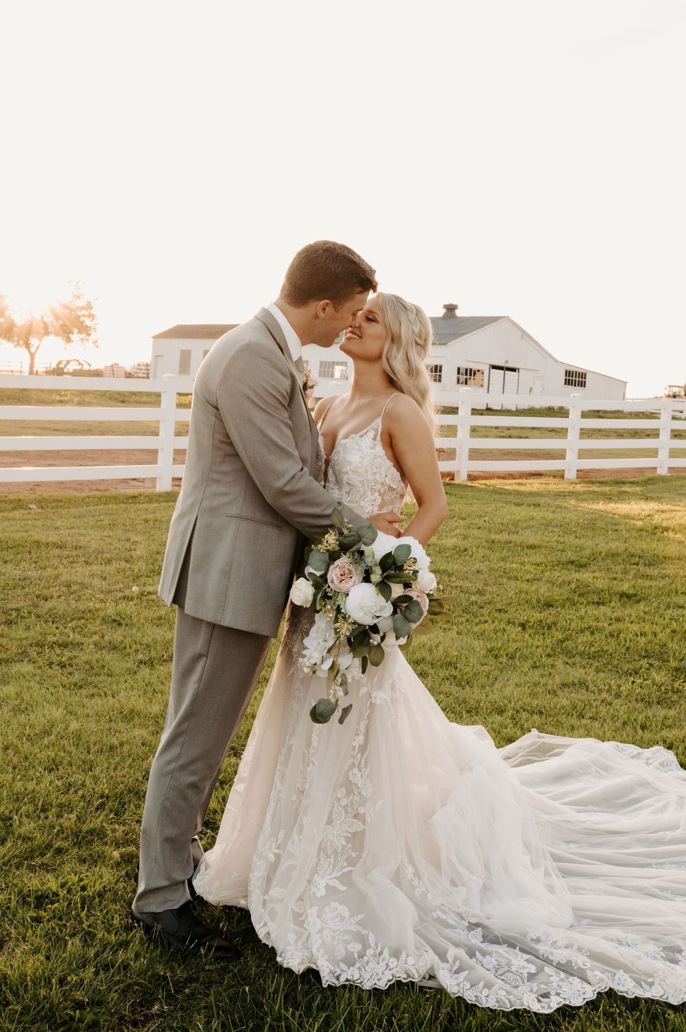 Romantic wedding portraits at sunset with white fence and sprawling field backdrop. Oklahoma Wedding Photographer