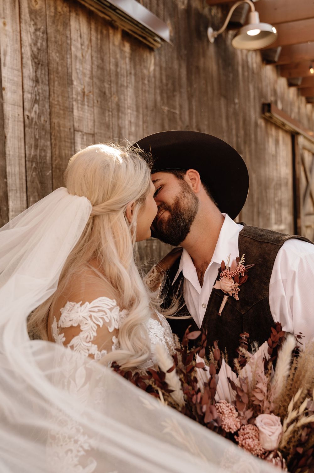 Intimate wedding portraits against rustic wooden barn wall. Oklahoma Wedding Photographer