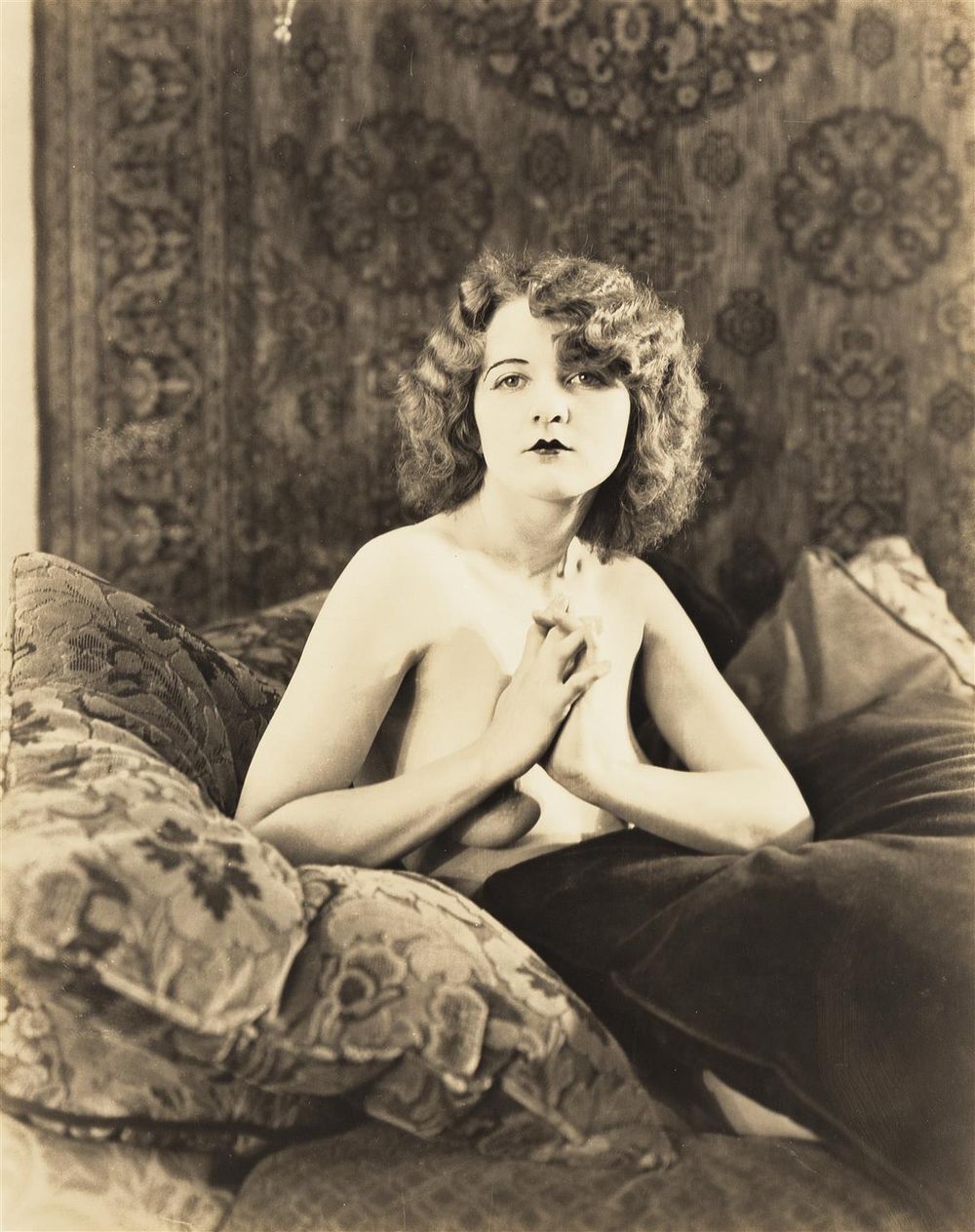 Vintage glamour portrait in black and white featuring classic 1920s styling and decor.