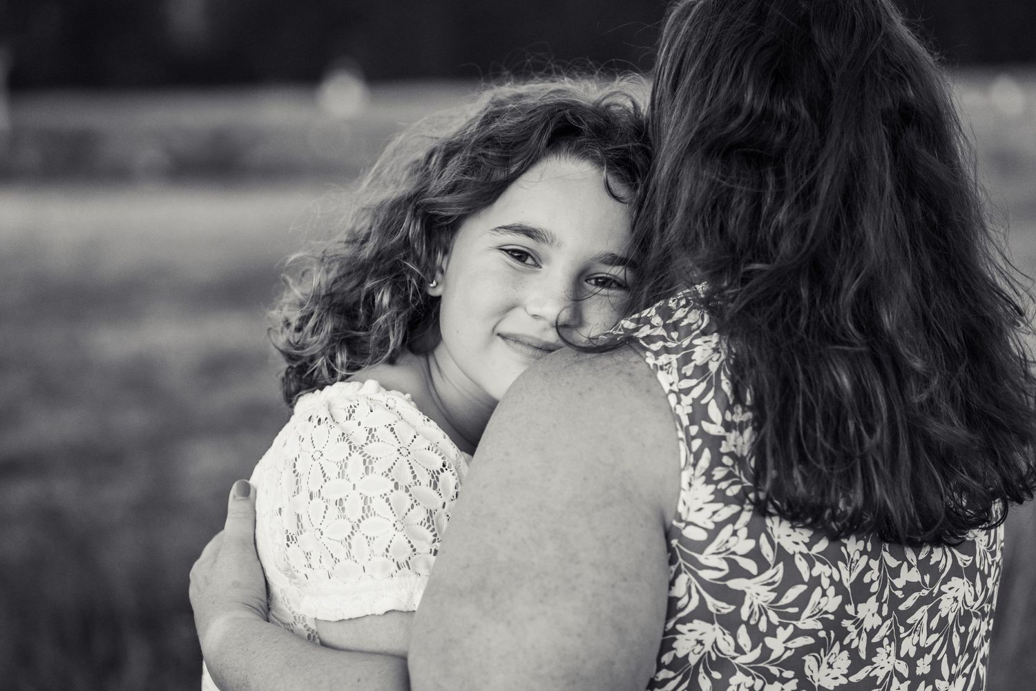 Daughter cuddling with mother at Marymoor Park