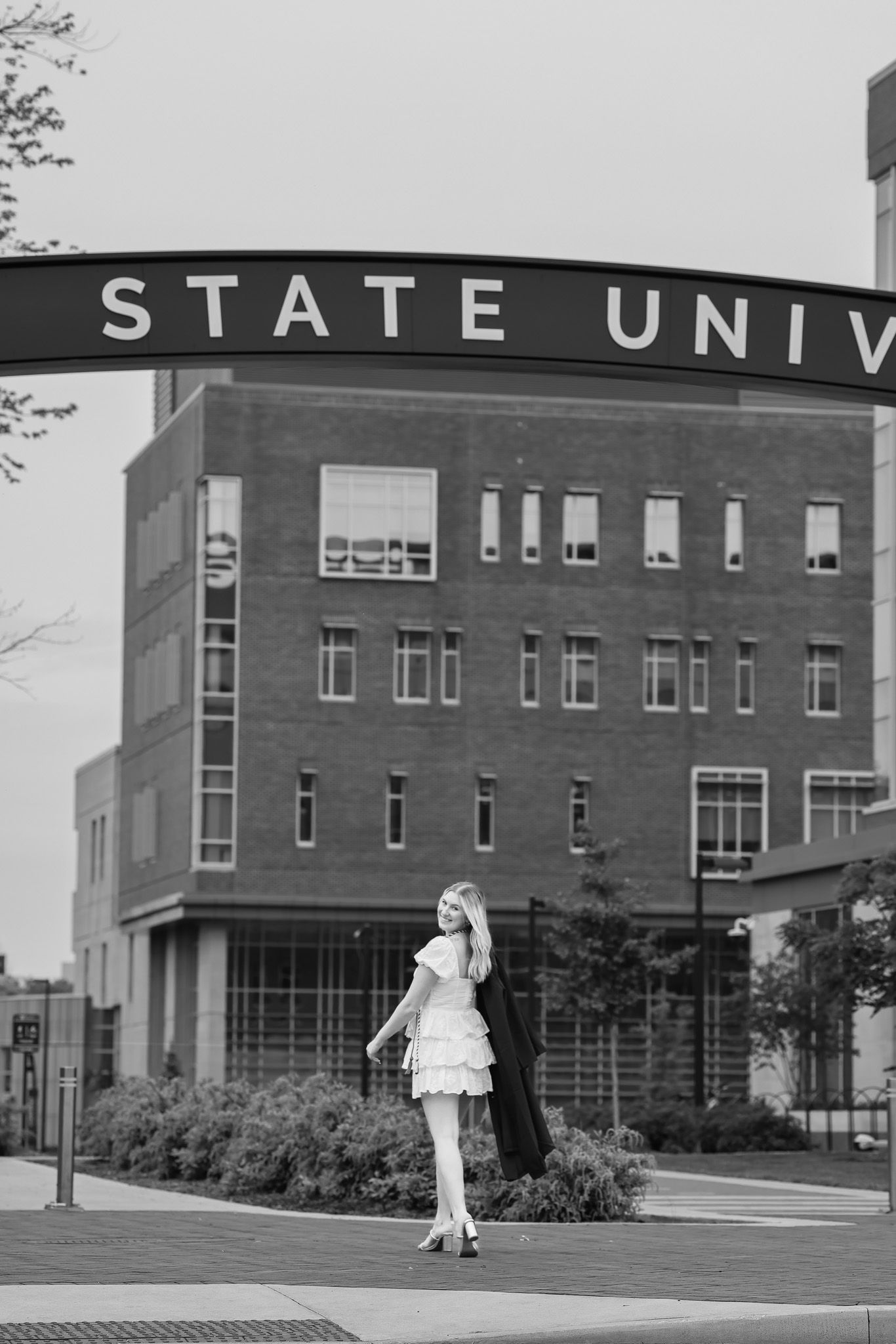 Black and white photo of a State University building with signage visible.