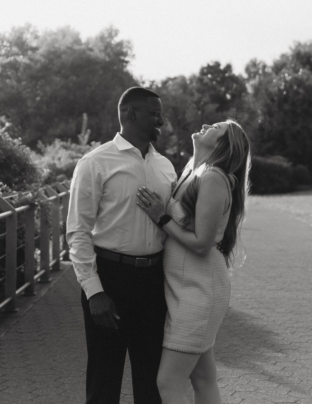 A couple shares a joyful moment together during an outdoor photoshoot.