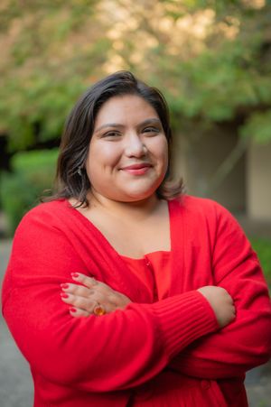 Portrait series shows person in bright red sweater striking different poses against blurred natural background.